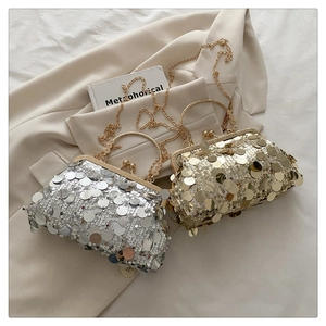 Detailed close-up of shiny sequin evening bags with vintage metal ring handles and chains
