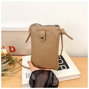 Close-up of litchi pattern PU leather phone bag with metal buckle and knot detail