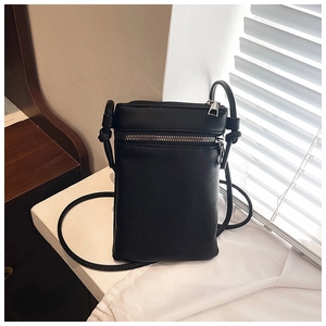 Detailed close-up of black lychee-textured leather mobile phone crossbody bag with silver zips