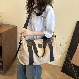 Large khaki waterproof Oxford cloth travel bag with wide black nylon straps and fashion logo