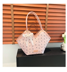 Detail of pink pleated tote bag with black bow embroidery and white lace pearl charm