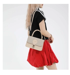 Detail of beige tote bag with woven texture flap, gold twist lock and Fashion logo