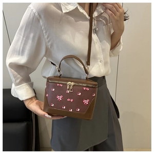 Brown box-shaped crossbody bag with cherry pattern and dual metal zippers detail