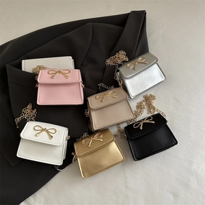 Chic mini crossbody bags with gold bow accents and chain straps in six vibrant colors