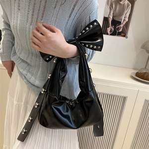 Retro black shiny leather tote bag with oversized bow and silver rivet studs