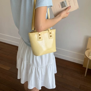 Fashionable yellow oil wax leather bucket bag for women with golden round buckles