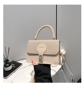 Dettaglio della borsa a tracolla crema con trama intrecciata e logo fashion a rilievo