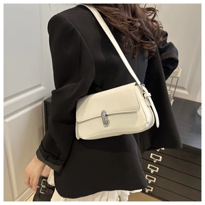 Close-up of minimalist white leather shoulder bag featuring a sleek silver metal buckle