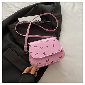 Close-up of pink crossbody bag featuring sweet cherry prints and neat stitching details