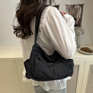 Casual dark wash denim shoulder bag with multiple pockets and contrast stitching detail