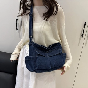 Deep blue denim crossbody bag with multiple flap pockets and adjustable strap for women