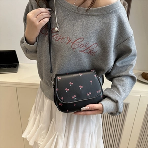 Black cherry print crossbody bag for women shown as a stylish side-view shoulder bag