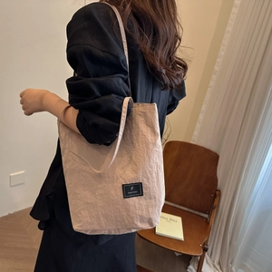 Light brown pleated bucket bag for women with minimalist shoulder strap design