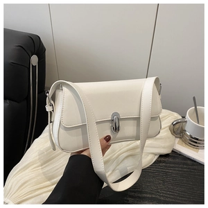 Detail of the elegant white underarm bag featuring a silver metal twist lock and sleek texture