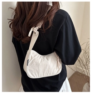 Chic cream crescent shoulder bag featuring stylish knotted strap and nylon texture