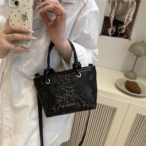 Fashionable black snake-pattern crossbody bag with gold lettering and knotted handle