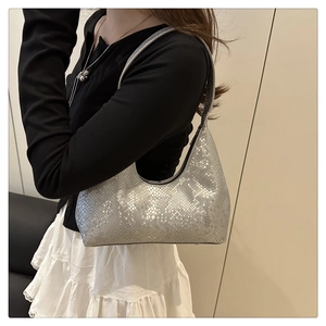 Close-up of silver snakeskin texture on a minimalist crescent hobo shoulder bag