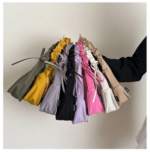 Close-up of colorful nylon hobo bags with pleated straps and decorative drawstring ties