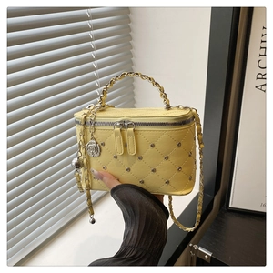 Quilted yellow box mini bag with metal studs, leather chain handle and flower charm detail