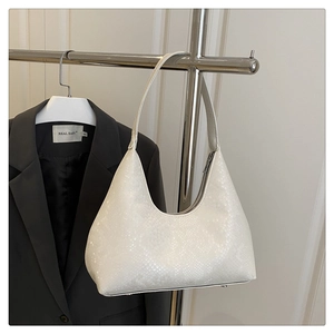 Detail of white half-moon hobo bag with snake pattern embossing and elegant zipper