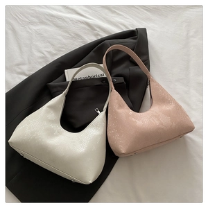 Detail of crescent shoulder bags with snake pattern texture in pearl white and pink leather