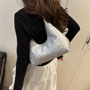 Silver crescent moon shoulder bag with snake skin pattern on female model in bright room