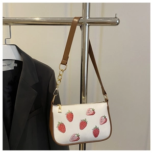 Detail of white PU shoulder bag with realistic strawberry print and gold chain strap