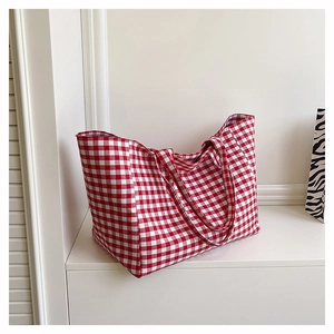 Close-up of red and white checkered canvas tote bag with durable double shoulder straps