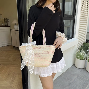 Large woven beach tote with colorful dots and a white lace bow for summer vacations