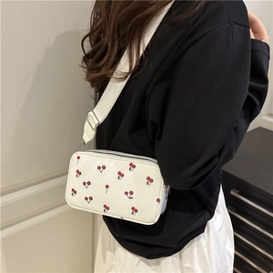 White casual crossbody bag with red cherry prints and wide fabric shoulder strap