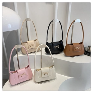 Detailed display of vintage underarm bags in five colors with gold bow accents
