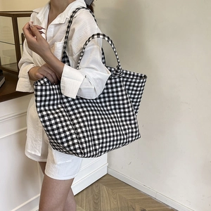 Minimalist black and white checkered canvas tote bag with dual shoulder straps for daily use