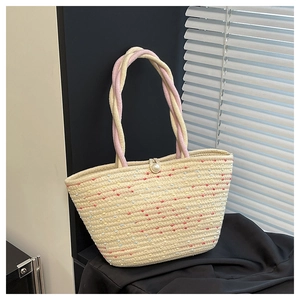 Close-up of woven tote bag featuring colorful polka dots and a large pearl fastener