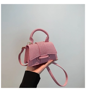 Detail of mini striped fabric handbag with pink and white patterns and elegant handle
