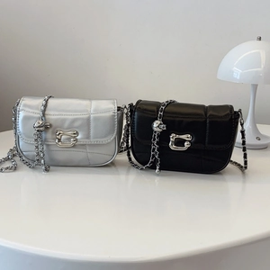 Quilted crossbody bag with gold ball chain and metallic clasp in black and silver