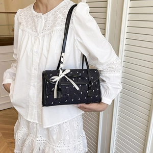 Chic black mini bowling bag with white lace bow and textured pattern for women