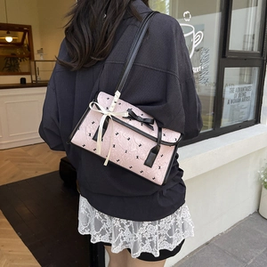 Pink ribbon bow shoulder bag with black rabbit pattern in a stylish street style view