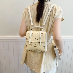 Mini yellow backpack with cartoon dachshund print and white straps for women