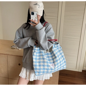 Blue plaid tote bag showcased by model in casual outfit for daily lifestyle and travel