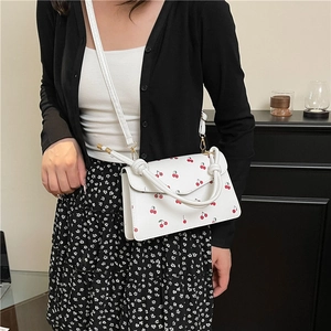 White leather crossbody bag with red cherry prints and gold hardware for women