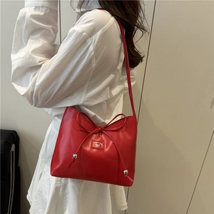 Red leather shoulder bag with a stylish bow knot and metallic silver sphere charms