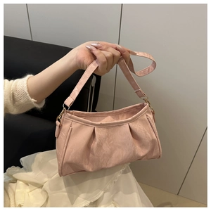 Detail of light pink pleated cloud bag with marble texture and gold metal buckles