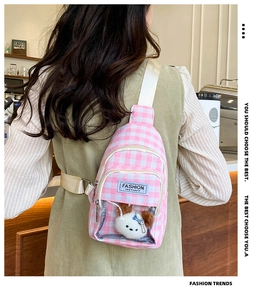 Detail of pink plaid chest bag featuring a transparent pocket with a cute plush puppy toy