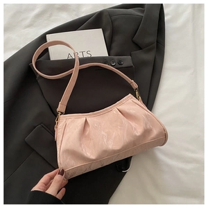 Detail of pink pleated cloud bag featuring glossy marble texture and gold metal hardware