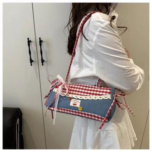 Détail du sac à bandoulière en jean bleu avec vichy rouge et broderies de cerises