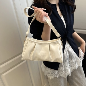 Creamy white ruched underarm bag with gold hardware and stylish pleated cloud design