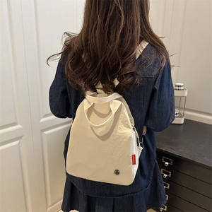 Minimalist beige fashion backpack for women in waterproof nylon with red side label
