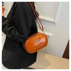 Orange vintage PU leather crossbody bag with silver rivets and sleek metallic branding