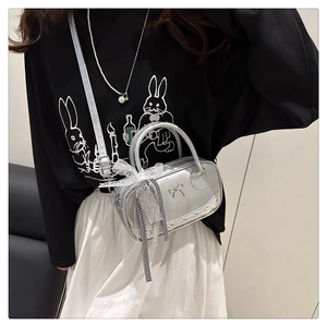 Detail of silver shiny mini Boston bag with lace bows and metallic butterfly buckle