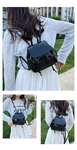 Detail of black mini drawstring backpack in glossy faux leather showing flap texture